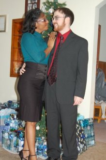 Green top, black pencil skirt, and black fascinator 2